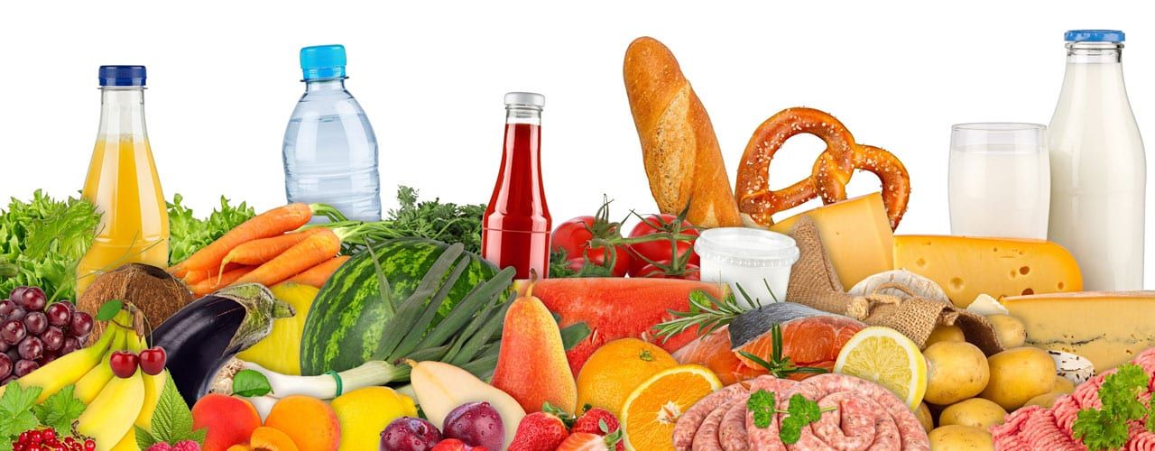 Spread of bread, fruit, vegetables and bottled drinks