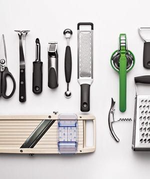 Kitchen tools laid out on a white surface