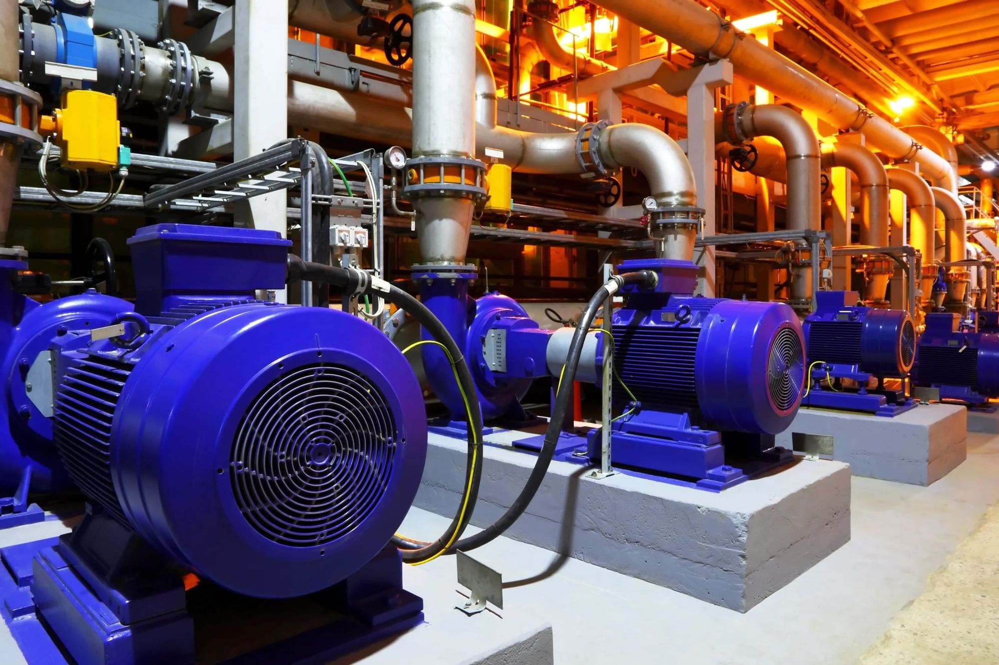 Blue pumps and pipework in a mechanical plant room