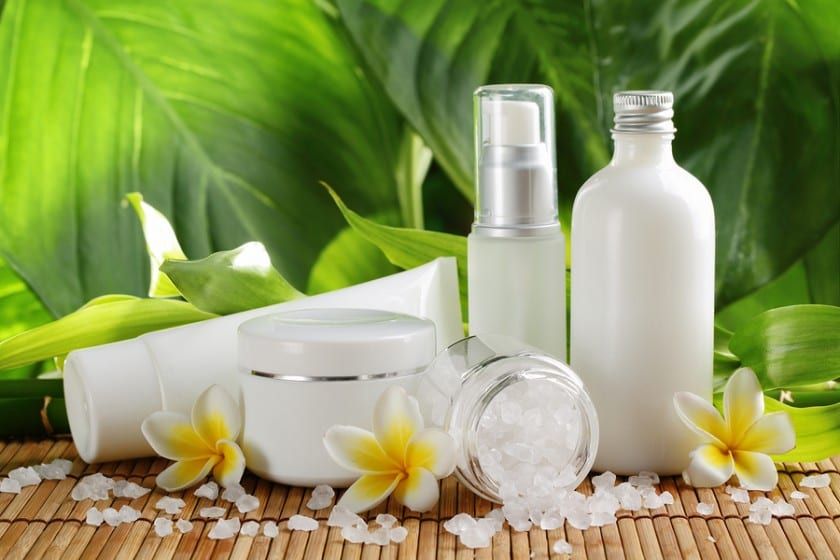 White spa bottles and jars with frangipani flowers