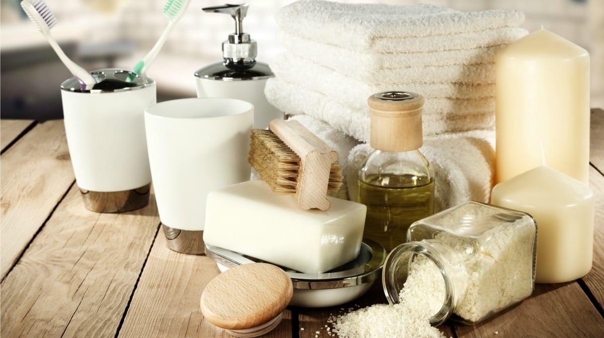 Spa towels, soaps and bath salts on a wooden tray