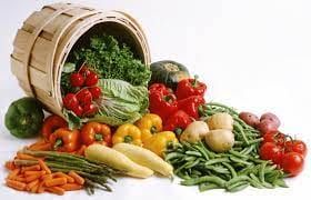 Basket spilling fresh vegetables onto a table